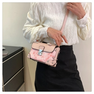 Detail of floral print patchwork bag with silver rivets and silk scarf handle