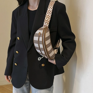 Retro crescent crossbody bag with geometric pattern and wide jacquard strap on a model