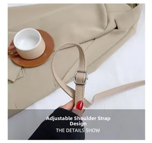 Detail of adjustable beige leather shoulder strap with silver buckle on elegant box bag