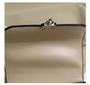 Close-up of the silver metal clasp and fine stitching on the vintage embroidery box bag