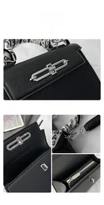 Details einer schwarzen Handtasche aus Leder mit Silberverschluss und Seidenschal-Griff