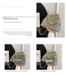 Detail view of green woven textured handbag with gold chain handle and dimensions 27x23x8cm