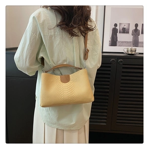 Chic light yellow snake-patterned PU leather handbag styled as a casual shoulder bag