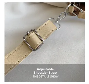 Close-up of adjustable faux leather shoulder strap with silver metal lobster clasp
