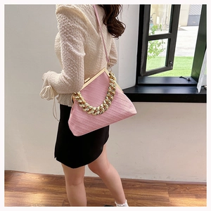 Pink shell handbag featuring textured stripe fabric and golden chunky chain handle detail