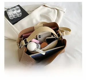 Large capacity bucket bag showing interior space for phone, umbrella and cosmetics