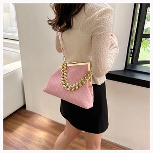 Detail of pink woven shell bag with vintage gold metal clasp and chunky chain strap