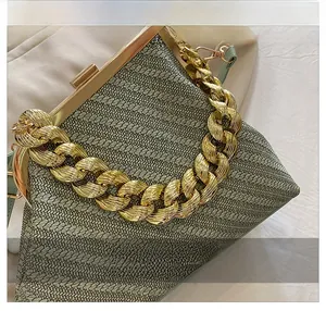 Detail of light green woven shell bag featuring a thick gold chain and retro metal clasp
