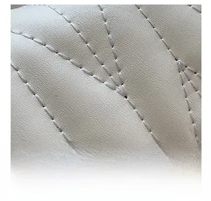 Detail of premium lychee texture leather with elegant quilted stitching on a crossbody bag