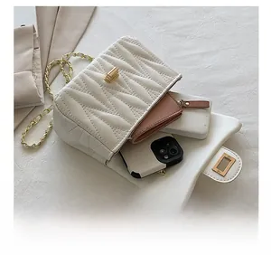 Internal view of a white quilted chain bag showing space for a pink wallet and phone