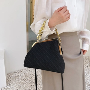 Vintage black shell bag with textured stripes, gold metal clasp and chunky chain strap