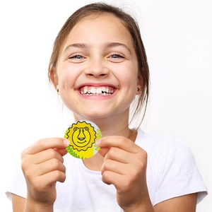 Smiling girl holding 1 inch cartoon lion animal stickers for kids reward and decoration