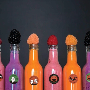 Halloween self-adhesive labels featuring ghost, pumpkin, and bat designs on juice bottles