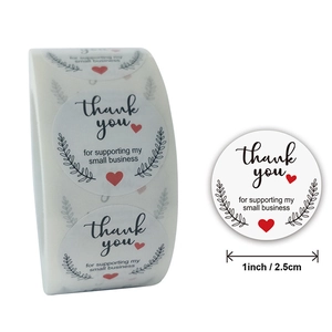 Detail of 1-inch thank you sticker roll featuring elegant olive branch and heart design