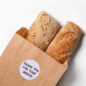 White round 'Thank You For Your Order' sealing stickers on craft paper bread bags