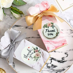 Floral Thank You stickers on marble gift boxes with elegant satin bows and white roses