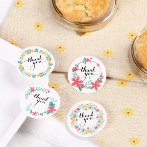 Floral Thank You stickers for gift sealing shown in 4 patterns on a beige linen background