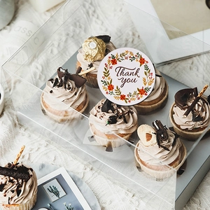 Floral Thank You stickers on bakery boxes with decorative wreath design and elegant lettering