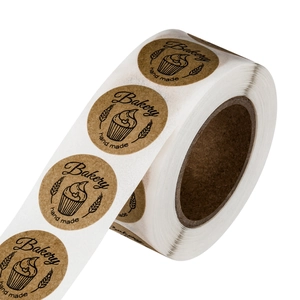 Roll of kraft paper bakery stickers featuring handmade cake and wheat ear motifs