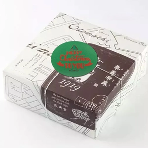 Retro Christmas gift box with festive Merry Christmas stickers and vintage paper wrap