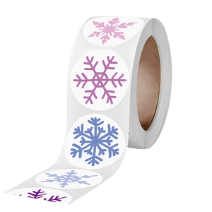Roll of colorful snowflake stickers in pink, blue and purple for Christmas gift decoration
