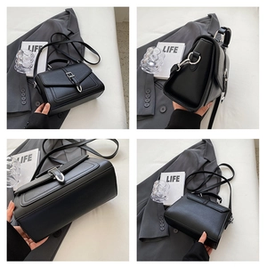 Detail views of black leather crossbody bag with silver buckle and top handle