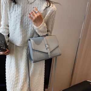 Elegant light gray lychee grain leather crossbody envelope bag with silver buckle