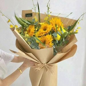 White and brown kraft paper roll for wrapping a sunflower bouquet with jute twine