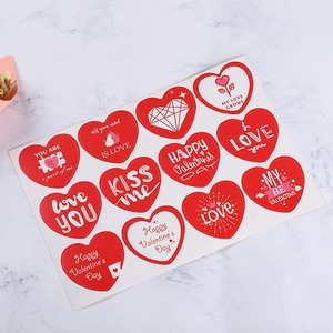 Set of 12 red heart Valentine's Day stickers with romantic quotes on marble surface