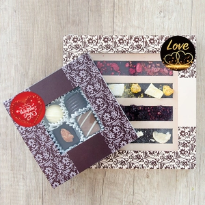 Detailed view of handmade chocolate gift boxes with assorted nuts and dried strawberry