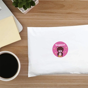Cartoon bear sticker with Super text on white shipping envelope over a desk background