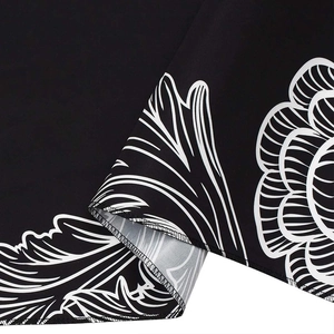 Nordic feather wind chime tapestry with white floral print on black woven fabric