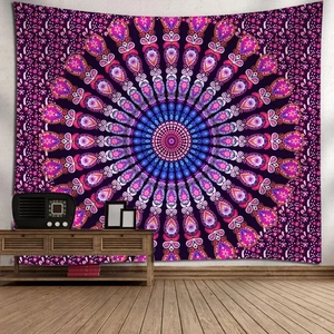 Detailed view of bohemian purple mandala tapestry hanging on a white wall in a modern living room