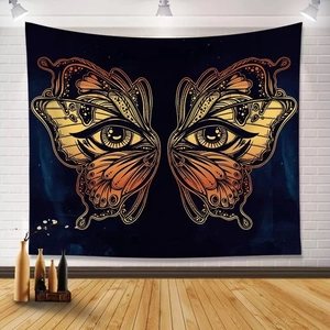 Detailed view of black cat and butterfly tapestry hanging on a white brick wall