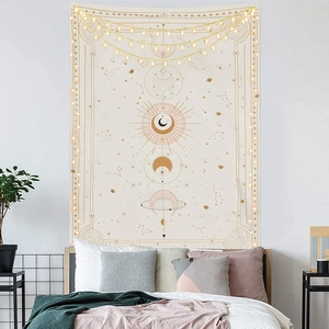Detail of lunar cycle and celestial sun motifs on a bohemian aesthetic wall tapestry