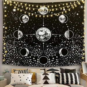 Bohemian bedroom setup featuring a lunar cycle wall tapestry with stars and warm fairy lights