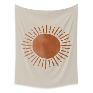 Bohemian solar tapestry with terracotta sunburst design on beige background hanging on wall