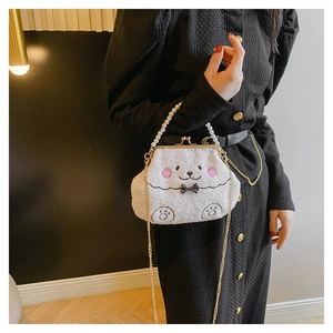 Detalle de bolso bandolera de peluche blanco con asa de perlas y cierre de metal retro