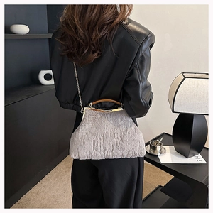 Furry evening clutch bag featuring a vintage gold metal frame and elegant chain strap