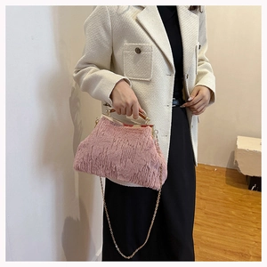 Pink faux fur evening bag featuring a gold chain strap and elegant wooden handle