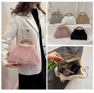 Detailed view of the plush evening bag interior showing capacity for cosmetics and chain strap