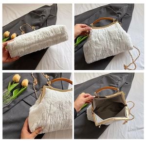 Detail view of white faux fur evening bag with gold frame and chain strap