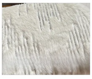 Detailed close-up of soft white faux fur fabric with sparkling silver sequins and stripes