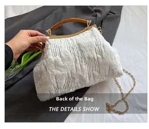 Detail view of white faux fur evening bag with gold metal frame and resin handle