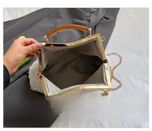 Detailed interior view of white faux fur bag with grey herringbone lining and gold clasp