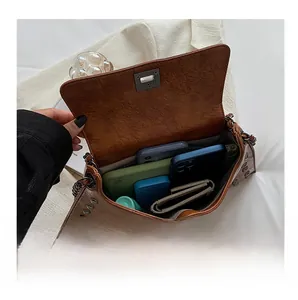 Interior view of vintage brown rivet bag showing spacious capacity for phone and wallet