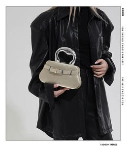 Détail du mini sac à main champagne doré avec poignée argentée et boucle métallique
