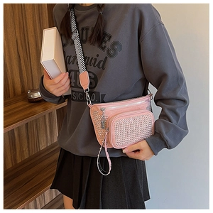 Detail of pink punk style waist bag with silver studs and geometric striped strap