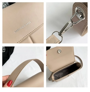 Dettaglio della borsa a sella beige con chiusura magnetica e accessori in metallo