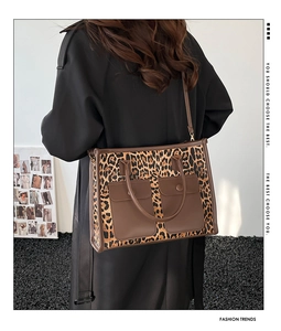 Detail of leopard print tote bag with dual front pockets and adjustable shoulder strap